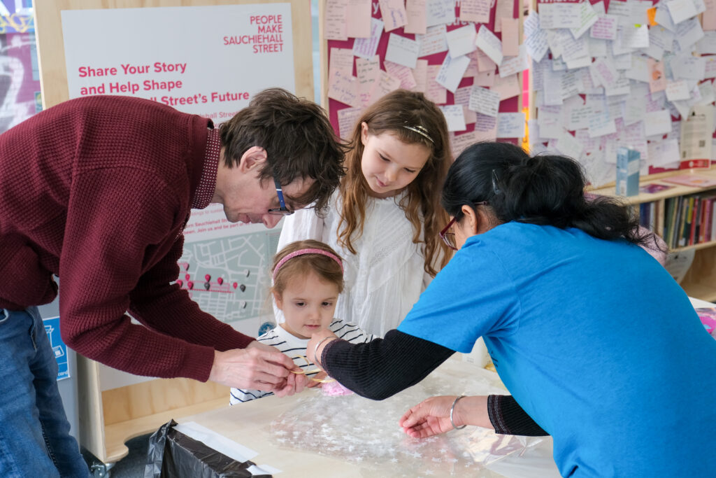 Three adults and a child gathered around a table