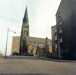 A large stone built church and spire