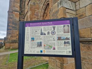 An information board with historical photos, drawings and text.