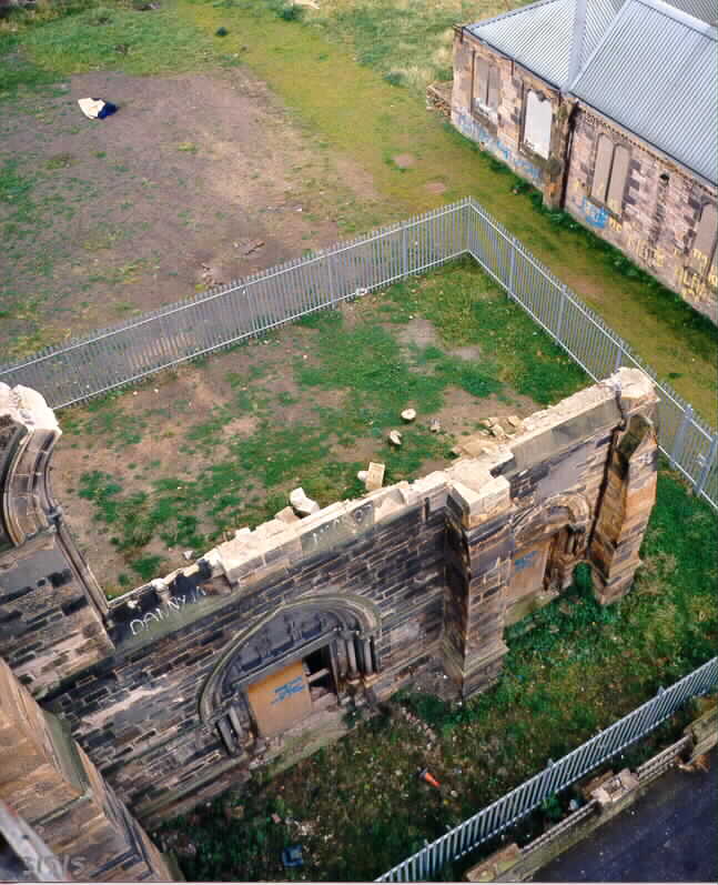 View looking down on a ruined wall and foundations